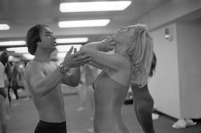 BEVERLY HILLS - 1982: Founder and teacher of Bikram Yoga, Bikram Choudhury assists actress Carol Lynley with the 'Standing Deep Breathing' posture at his yoga studio in Beverly Hills, California. (Joan Adlen/Getty Images)
