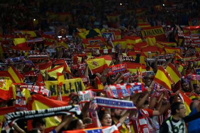 Atletico Madrid supporters hold up Spanish flags during a Spanish La Liga soccer match between Atletico Madrid and Barcelona at the Metropolitano stadium in Madrid, Saturday, Oct. 14, 2017. The match ended in a 1-1 draw. (AP Photo/Francisco Seco)