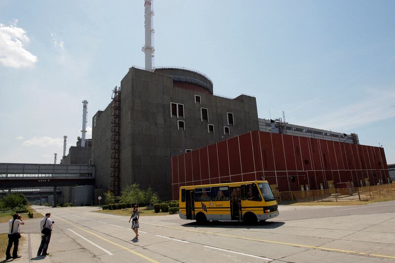 Russian forces have seized control of the Zaporizhzhia nuclear power station in Ukraine and cut off communication between staff and the outside world. Pictured, a woman posing outside the site in 2008.  Reuters
