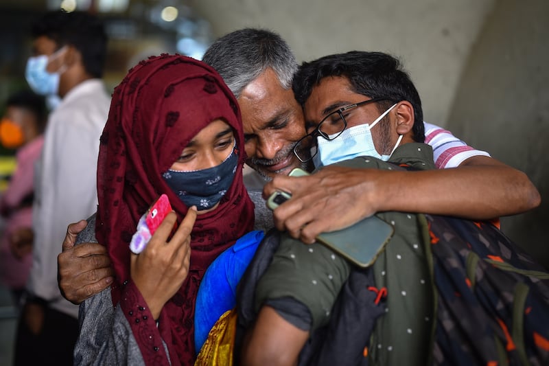 An Indian student is embraced by his family at Chennai Airport after returning from Ukraine. EPA