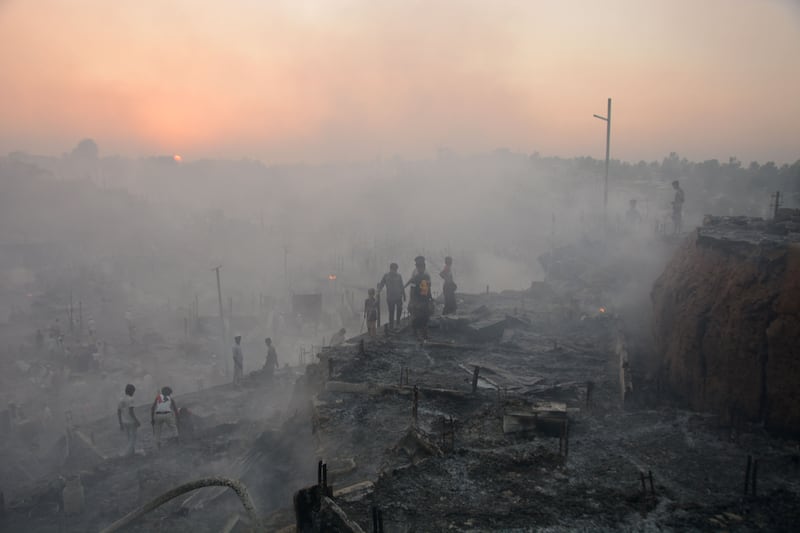 Rohingya refugees search for their belongings after a fire broke out at Balukhali refugee camp in Bangladesh. AFP
