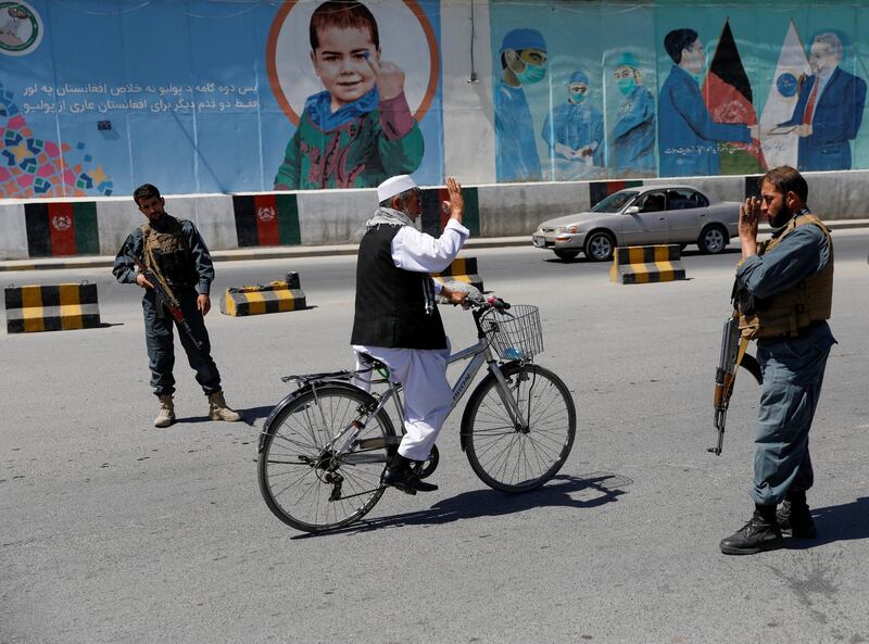 Afghan policemen stand guard at a check point during Eid Al Fitr, a Muslim festival marking the end of Ramadan. REUTERS