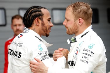 Lewis Hamilton, left, is congratulated by his Mercedes-GP teammate Valtteri Bottas on his win in China. Reuters