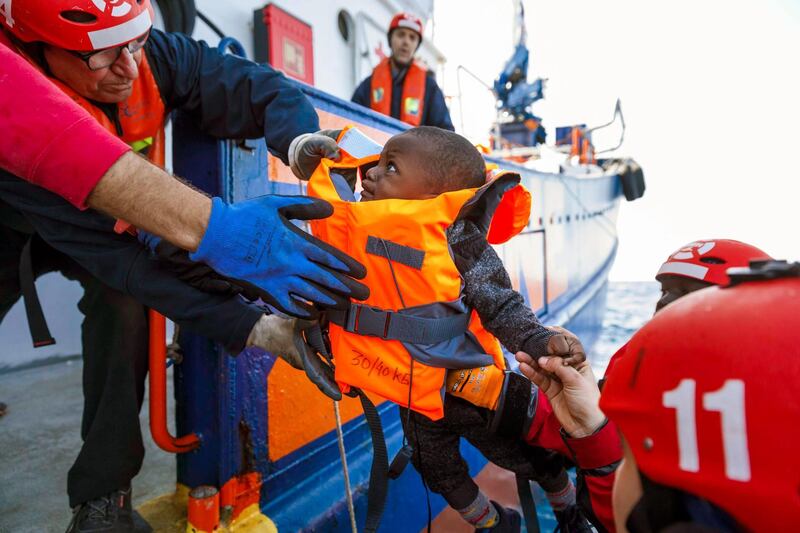 A baby is rescued by members of the Spanish NGO Maydayterraneo on board the Aita Mari rescue boat during the rescue of about 90 migrants in the Mediterranean open sea off the Libyan coast.  AFP