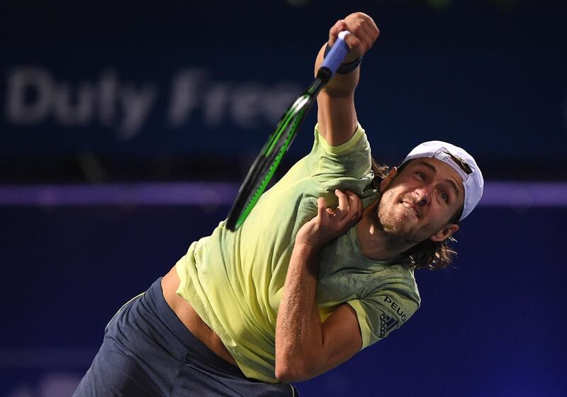 DUBAI, UNITED ARAB EMIRATES - FEBRUARY 27:  Lucas Pouille of France serves during his match against Ernests Gulbis of Latvia on day two of the ATP Dubai Duty Free Tennis Championships at the Dubai Duty Free Stadium on February 27, 2018 in Dubai, United Arab Emirates.  (Photo by Tom Dulat/Getty Images)