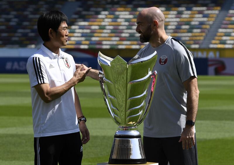 Japan's head coach Hajime Moriyasu, left, shakes hands with Qatar's head coach Felix Sanchez, right, during a photo session at the Zayed Sports City Stadium in Abu Dhabi ahead of their Asian Cup's final football match. AFP