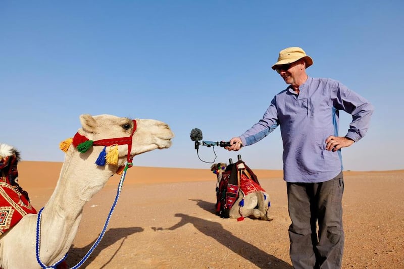 Outward Bound Oman founder and expedition leader Mark Evans with a camel in the Saudi desert