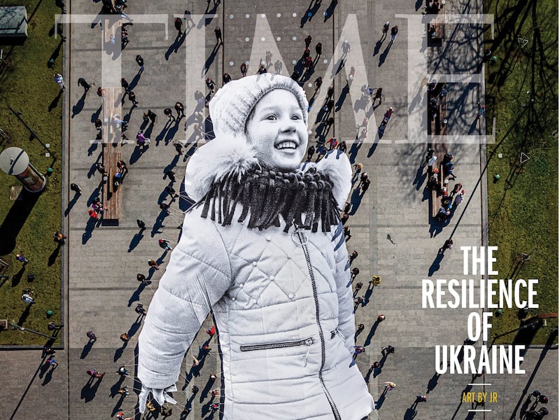 The cover of 'Time' magazine's 'The Resilience of Ukraine' issue features JR's artwork, a 45-metre tarp print of a photograph of young Ukrainian refugee Valeriia. Photo: Time