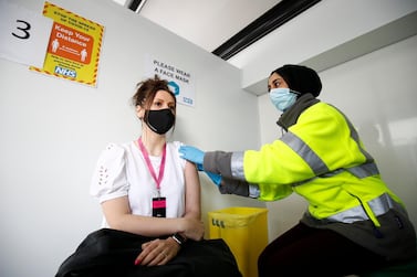Eve Westwell, 29, receives a dose of Pfizer-BioNTech's Covid-19 vaccine in Blackburn, England. UK MPs called for a 'one in, one out' policy for sending vaccines to developing countries. Reuters 