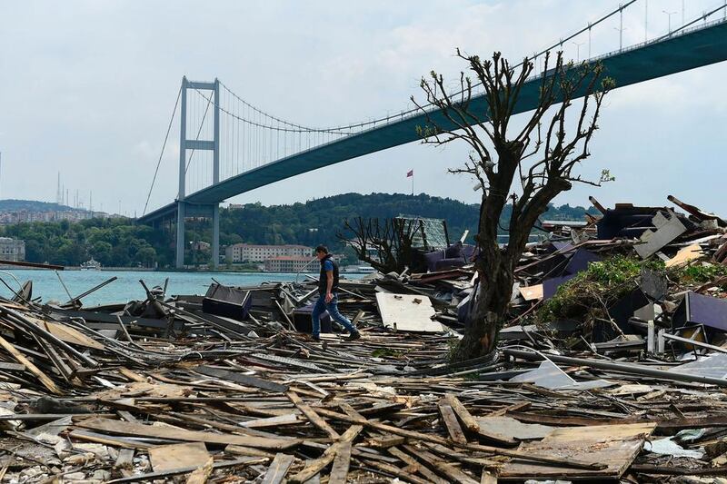 A man walks through debris from the demolition of the Reina nightclub on May 22, 2017, near Bosphorus bridge in Istanbul. Yasin Akgul / AFP