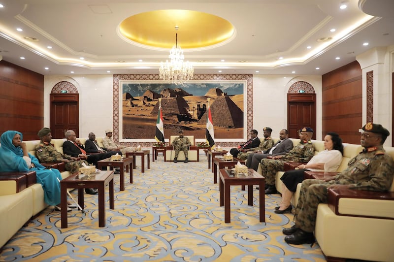 Leader of Sudan's transitional council, Lieutenant General Abdel Fattah Al-Abdelrahman Burhan meets military and civilian members of Sudan's new ruling body, the Sovereign Council, after their swearing-in ceremony at the presidential palace in Khartoum, Sudan. Reuters