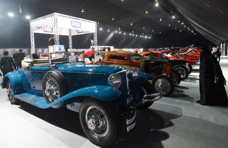 A Saudi woman looks at classic cars displayed for sale at a special exhibition in the Riyadh Motor Show, at Al-Janadriyah village in the Saudi capital. AFP