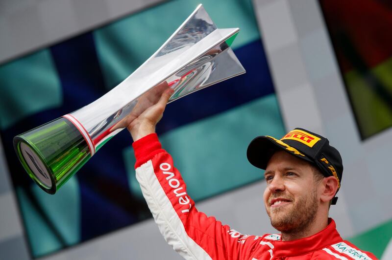 epa06799382 German Formula One driver Sebastian Vettel of Scuderia Ferrari celebrates with the trophy after winning the 2018 Canada Formula One Grand Prix at the Gilles Villeneuve circuit in Montreal, Canada, 10 June 2018.  EPA/VALDRIN XHEMAJ