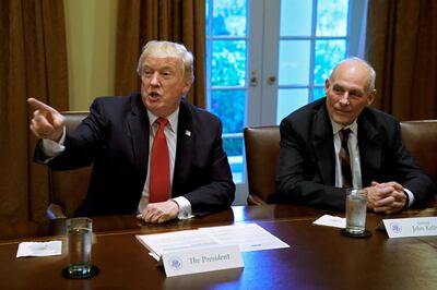 FILE PHOTO: U.S. President Donald Trump gestures next to White House Chief of Staff John Kelly during a briefing with senior military leaders at the White House in Washington, DC, U.S., October 5, 2017. REUTERS/Yuri Gripas/File Photo