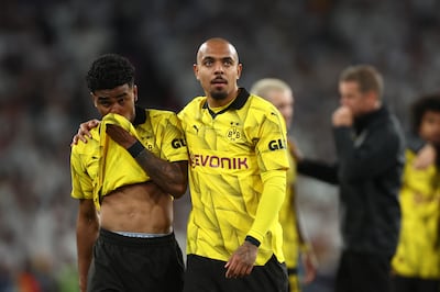 Ian Maatsen of Borussia Dortmund is consoled by Donyell Malen following their defeat. Getty.