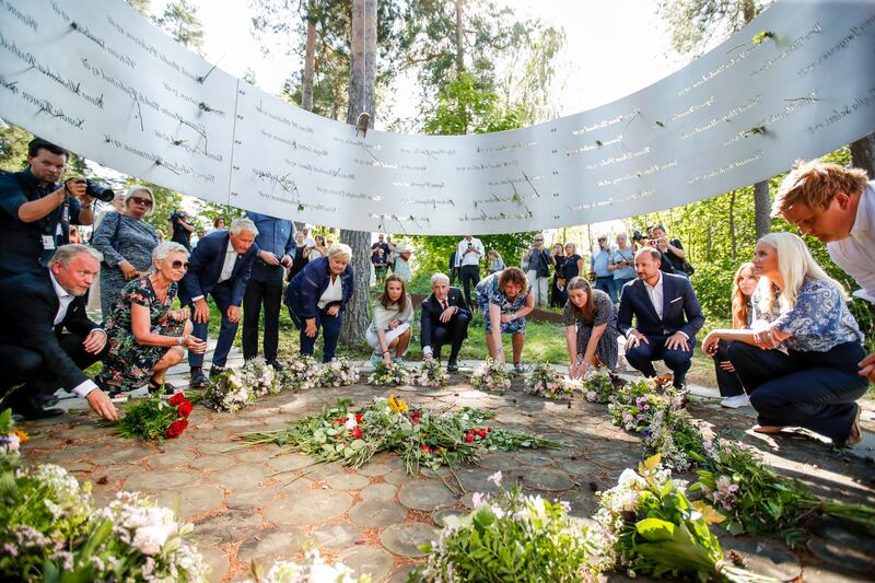Dignitaries including Norwegian Prime Minister Erna Solberg, Crown Prince Haakon Magnus and Crown Princess Mette-Marit lay floral tributes at the memorial service for the victims of mass killer Anders Breivik on the island of Utoya, Norway, on July 22, 2021. AP