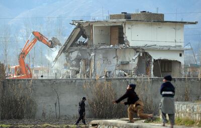 (FILES) In this file photograph taken on February 26, 2012, Pakistani children play near demolition works on the compound where Al-Qaeda chief Osama bin Laden was slain last year in the northwestern town of Abbottabad. Almost every day, children play cricket in a patch of scorched grass and scattered rubble in Abbottabad -- all that remains of the final lair of the most wanted person on the planet. It was in this Pakistani city that Osama bin Laden was killed in the clandestine "Operation Geronimo" raid by US Navy Seals in the early hours of May 2, 2011. The operation had global repercussions and dented Pakistan's international reputation -- exposing contradictions in a country that had long served as a rear base for Al Qaeda and its Taliban allies while suffering from the effects of terrorism.
 / AFP / Aamir QURESHI

