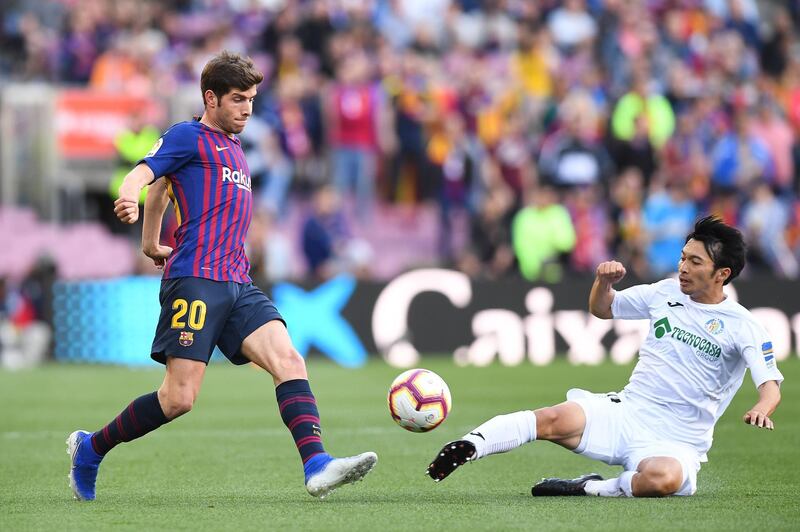 Barcelona's Sergio Roberto competes for the ball with Getafe player Gaku. Getty Images