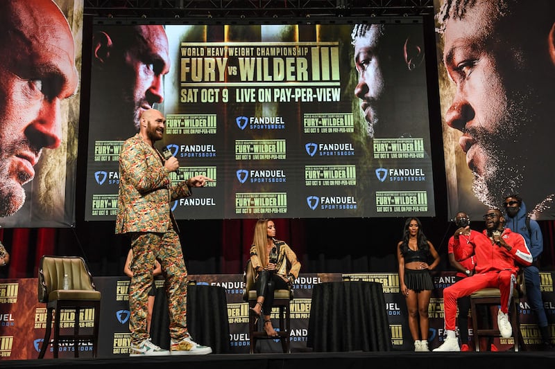 Tyson Fury (and challenger Deontay Wilder on stage. AFP