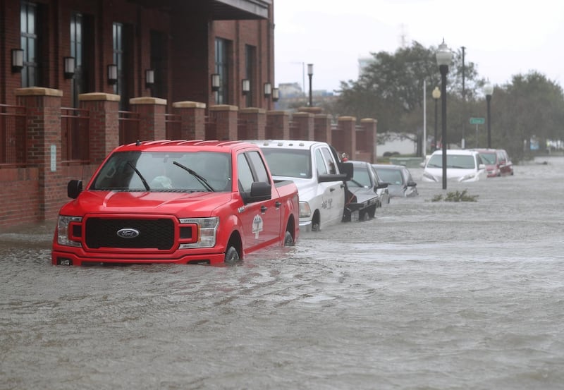 Vehicles are seen in a flooded street as Hurricane Sally passes through the area in Pensacola, Florida. AFP