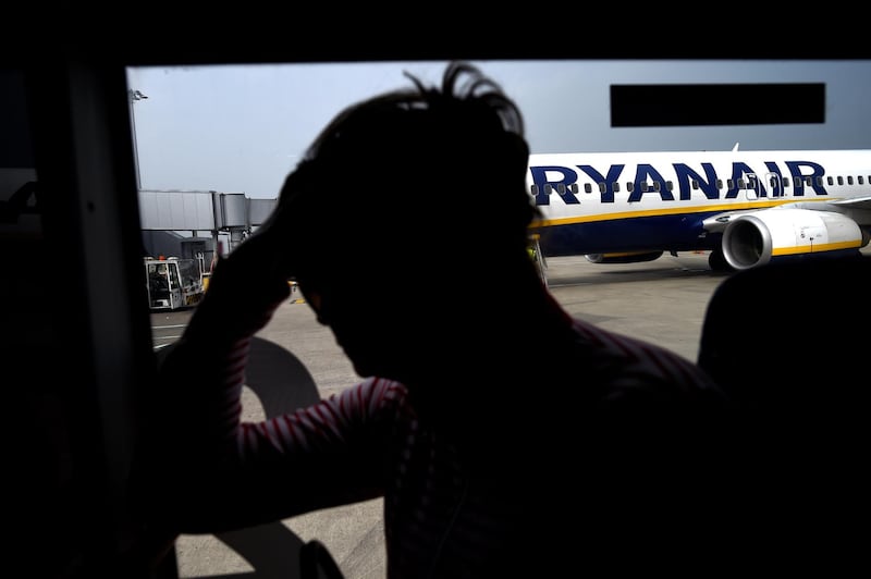 FILE PHOTO: A woman waits on a bus to be brought to the airport terminal from a Ryanair flight at Stansted airport in London, Britain September 27, 2017. REUTERS/Clodagh Kilcoyne/File Photo