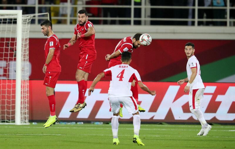 AL AIN , UNITED ARAB EMIRATES , January 10 ��� 2019 :- Players in action during the AFC Asian Cup UAE 2019 football match between Jordan ( white ) vs Syria ( red ) held at Sheikh Khalifa International Stadium in Al Ain. ( Pawan Singh / The National ) For News/Sports/Instagram