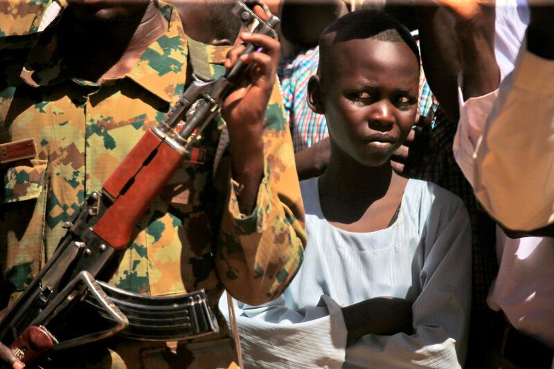 A child looks on as Sudan's prime minister visits a camp for internally displaced people (IDP) in El-Fasher, the capital of the North Darfur state. AFP