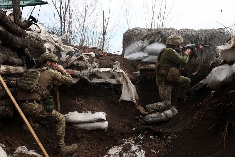 Ukrainian soldiers embedded in a trench on the front line in the Lugansk region. AFP