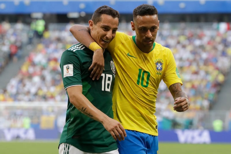 Brazil's Neymar, right, and Mexico's Andres Guardado, left, embrace during the round of 16 match between Brazil and Mexico. Andre Penner / AP Photo