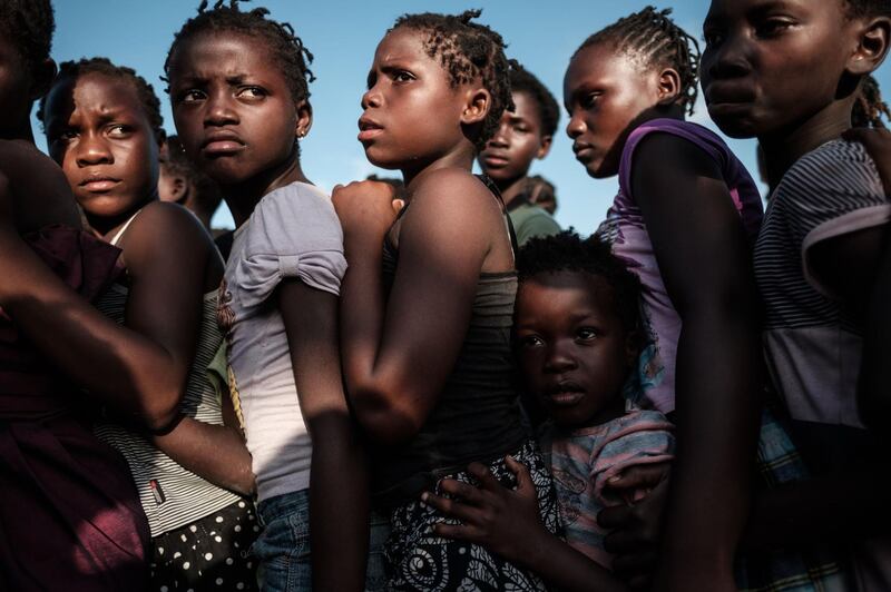 Children wait in line to receive food distribution from a local supermarket at an evacuation center in Dondo, about 35km north from Beira, Mozambique. AFP