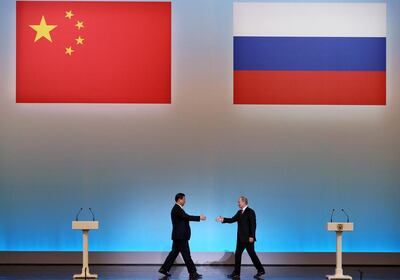 Xi Jinping, left, is welcomed by Vladimir Putin in Moscow in 2013. The Non-Aligned Movement must know there are figures in the West who do not wish to escalate tensions with either China or Russia. AFP