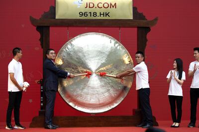 Xu Lei, head of JD Retail, second from left, sounds the gong to mark the listing of JD.com on the Hong Kong Stock Exchange at the JD.com headquarters in Beijing on Thursday, June 18, 2020. Chinese e-commerce firm JD.com's stock jumped nearly 6% on its debut in Hong Kong on Thursday after the firm raised $3.9 billion in a share sale. (AP Photo/Ng Han Guan)