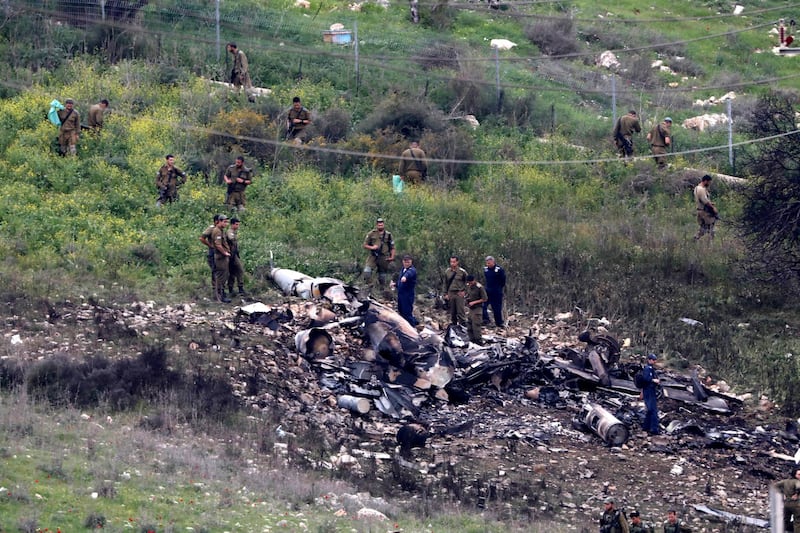 epaselect epa06511803 Israeli soldiers inspect the remains of an Israeli F-16 fighter jet that was shot down after a hit by Syrian anti-aircraft system, near the northern Israeli Kibbutz (collective community) of Harduf, 10 February 2018. An Israeli army spokesman said, Israeli army successfully intercepted an Iranian UAV (Unmanned Aerial Vehicle) that was launched from Syria and infiltrated Israeli airspace. In response, the army targeted Iranian locations in Syria. Israeli media reports that an Israeli F-16 warplane was shot down by Syrian anti-aircraft systems and the two crew ejected and parachuted to safety in Israel with the aircraft crashing in Israeli territory near Haifa.  EPA/ABIR SULTAN