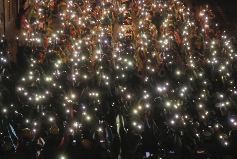 Pro-democracy protesters shine their mobile phone lights during an anti-government protest at Victory Monument during a protest in Bangkok, Thailand.  AP Photo