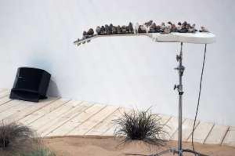 Finches sit on an electric guitar in the Barbican Centre's Curve Gallery in an installation by artist Celeste Boursier-Mougenot.
Credit: Lyndon Douglas