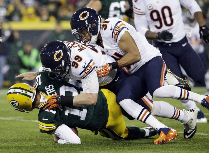 Aaron Rodgers, being sacked by Chicago's Shea McClellin and injuring his shoulder on Monday night. Morry Gash / AP
