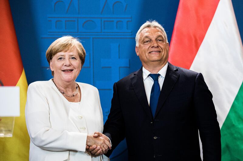 Angela Merkel, Germany's chancellor, left, shakes hands with Viktor Orban, Hungary's prime minister, following a news conference in Sopron, Hungary, on Monday, Aug. 19, 2019. With Europe’s largest economy slowing sharply and Merkel's coalition becoming increasingly unpopular, pressure has increased at home and abroad for the famously frugal Germans to open the purse strings.  Photographer: Akos Stiller/Bloomberg