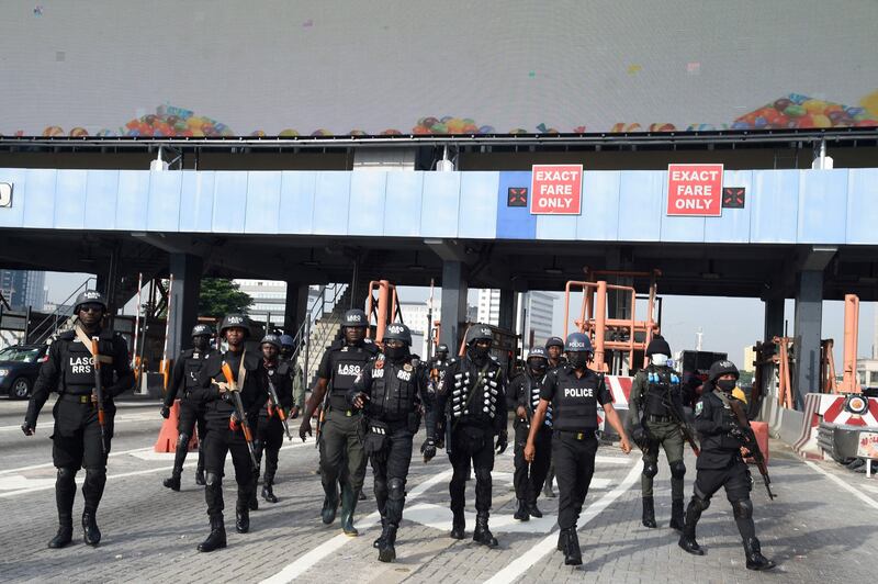 Police officers arrive at the scene of the rally to commemorate the one-year anniversary of the October 20, 2020 protest, when security forces shot at people gathered at the Lekki toll gate.  AFP