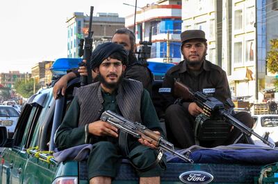 Taliban security forces stand guard at the scene of a bomb blast, in Kabul, Afghanistan. EPA