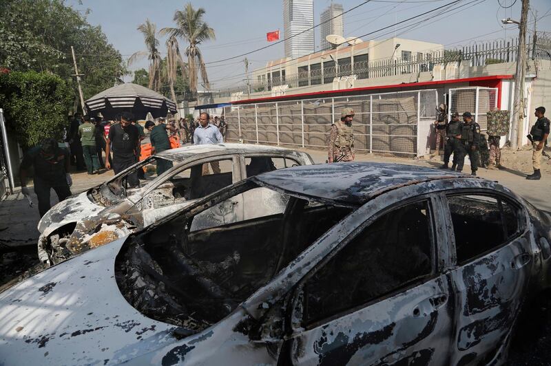 FILE - In this Nov. 23, 2018 file photo, Pakistani security personnel move in the compound of Chinese Consulate following a deadly attack, in Karachi, Pakistan. Aslam Baloch, one of the leaders of the Baluch Liberation Army, blamed for masterminding the attack on the consulate has been killed in a bombing in Afghanistan, Pakistani officials and the separatist group said Thursday, Dec. 27, 2018. (AP Photo/Shakil Adil, File)