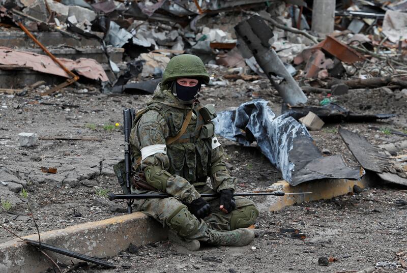 A Russian soldier takes a break during an operation to demine the territory of Azovstal steel plant in Mariupol. Reuters
