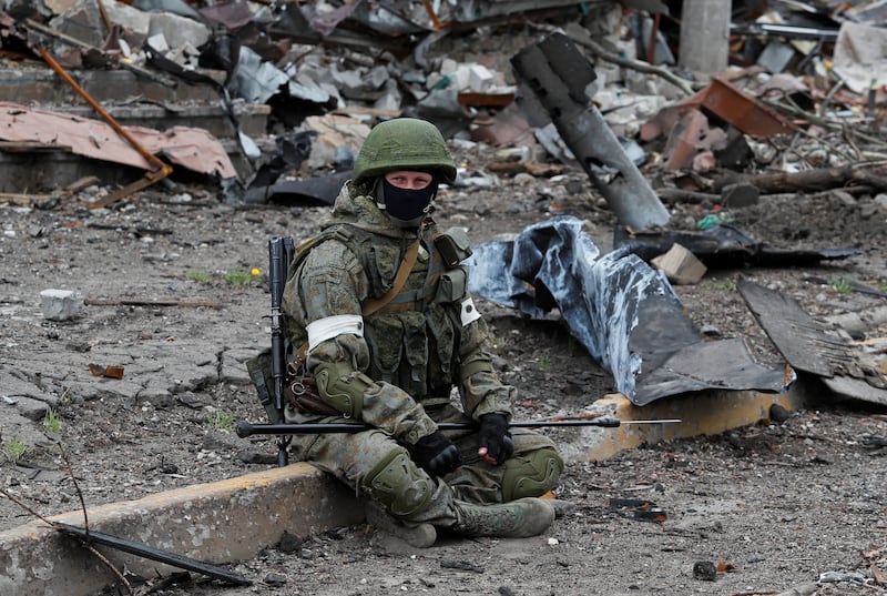 A Russian soldier takes a break during an operation to demine the territory of Azovstal steel plant in Mariupol. Reuters