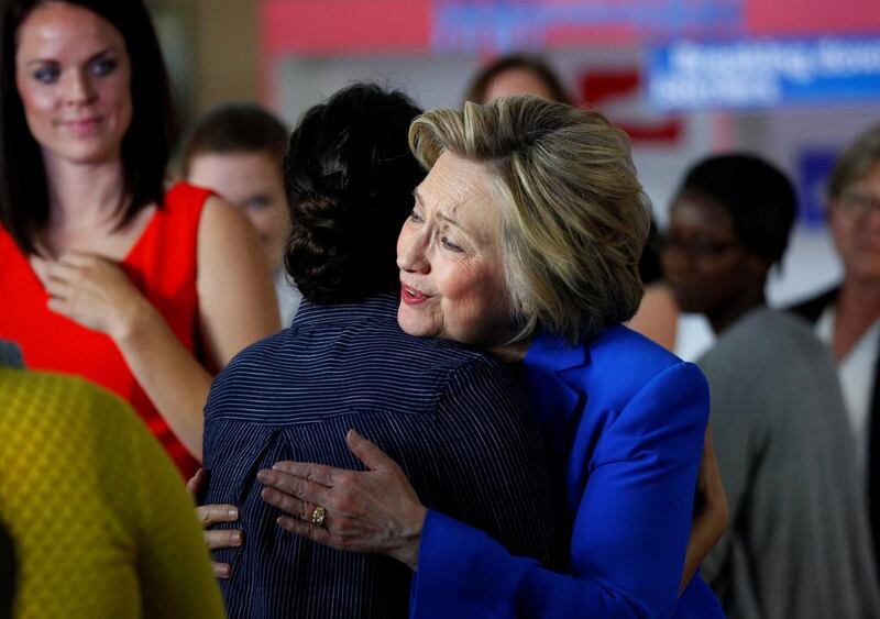 Democratic presidential candidate Hillary Clinton hugs a woman at campaign event for young parents. John Sommers II / Reuters / May 10, 2016