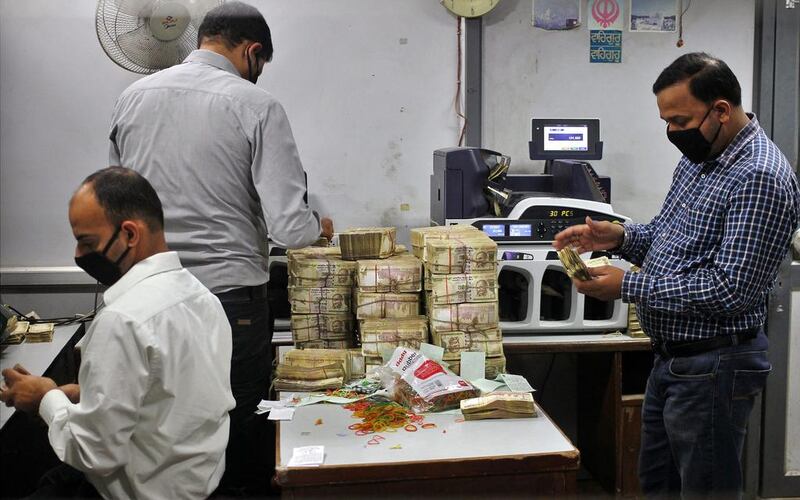 Employees count old 500-rupee notes at a bank in Jammu, India, on November 11, 2016. Mukesh Gupta / Reuters