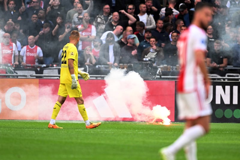 Ajax supporters throw flares onto the pitch during the Dutch Eredivisie soccer match between Ajax Amsterdam and Feyenoord Rotterdam in Amsterdam, the Netherlands, 24 September 2023.   EPA / OLAF KRAAK