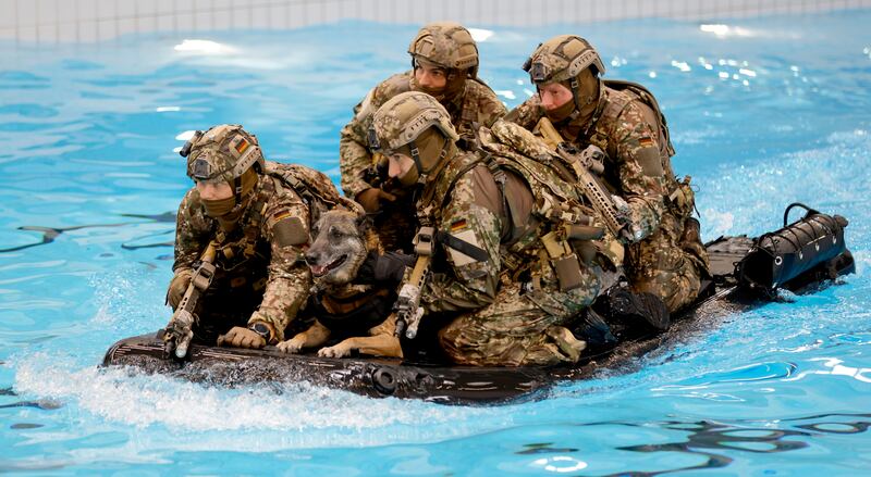 Soldiers carry out an exercise during Mr Scholz's visit in the southern German town. EPA