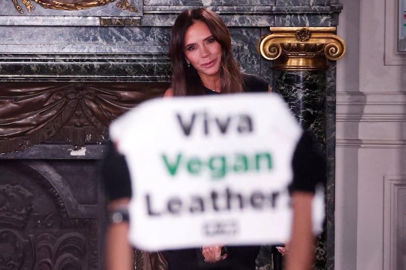 An activist from animal rights group Peta protests in front of Victoria Beckham at her show at the Paris Fashion Week, over her use of animal products. Reuters