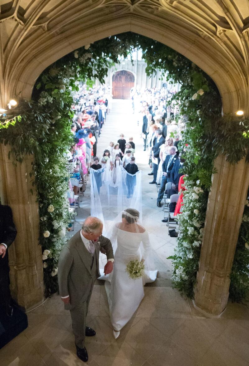 WINDSOR, UNITED KINGDOM - MAY 19: Meghan Markle walks up the aisle with the Prince Charles, Prince of Wales at St George's Chapel at Windsor Castle during her wedding to Prince Harry on May 19, 2018 in Windsor, England.. (Photo by Dominic Lipinski/ - WPA Pool/Getty Images)