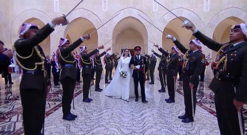 An honour guard surrounds the royal couple as they arrive at Al Husseiniya Palace. Reuters