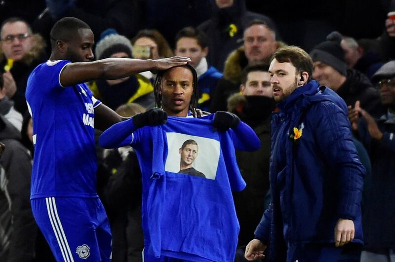 Cardiff City's Bobby Reid celebrates scoring their first goal by displaying a shirt paying tribute to Sala. Reuters